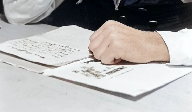 A handwritten thank-you note rests beside an addressed envelope, illustrating themes of gratitude, personal correspondence, and thoughtful communication explored in Elliot Ackerman's essay A Man Should Know: How to Say Thank You.