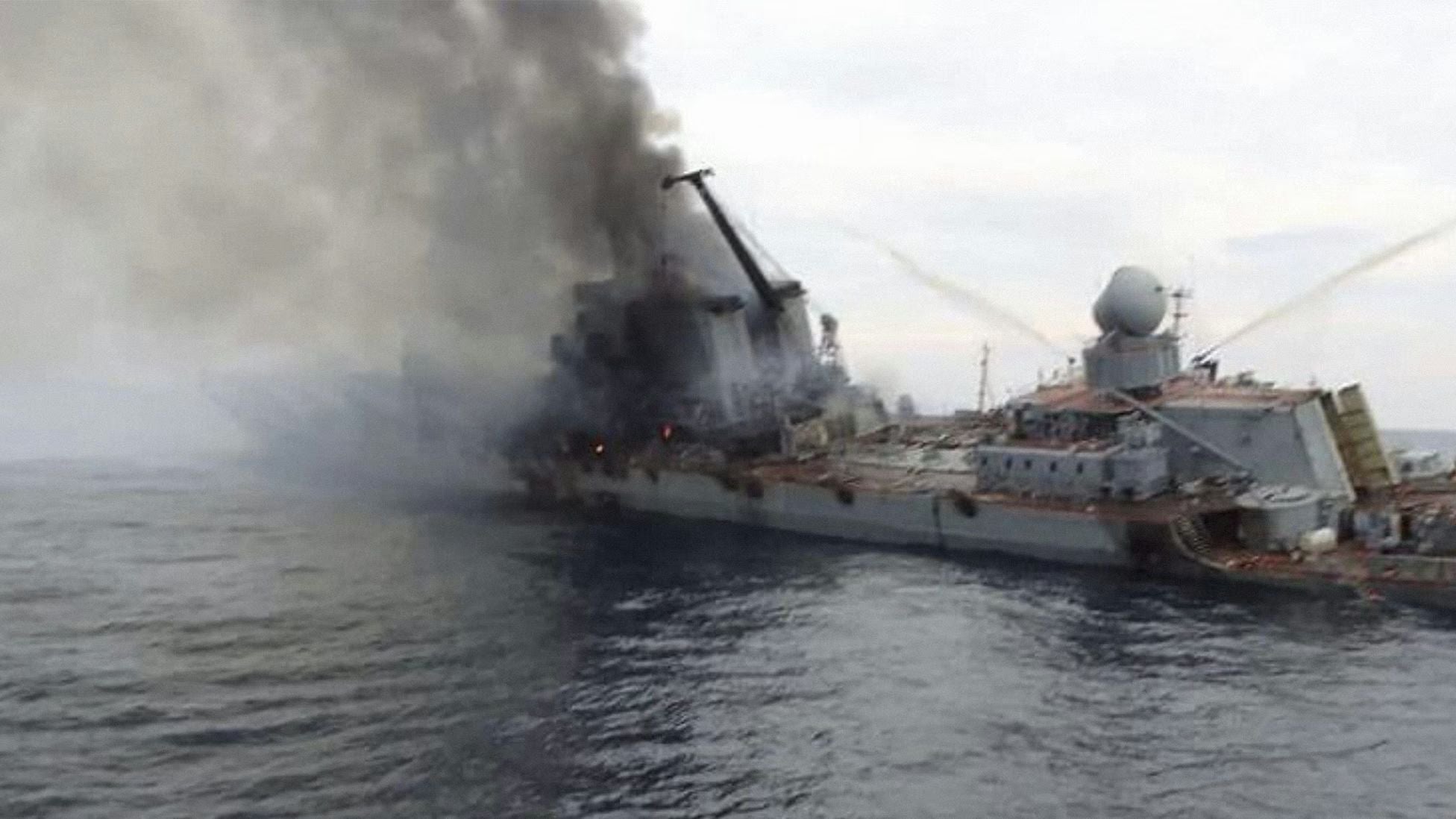 The Russian Black Sea Fleet cruiser Moskva heavily damaged and listing at sea, with thick black smoke billowing from the vessel after a missile strike during the Russia-Ukraine war, highlighting a pivotal moment in modern naval warfare.