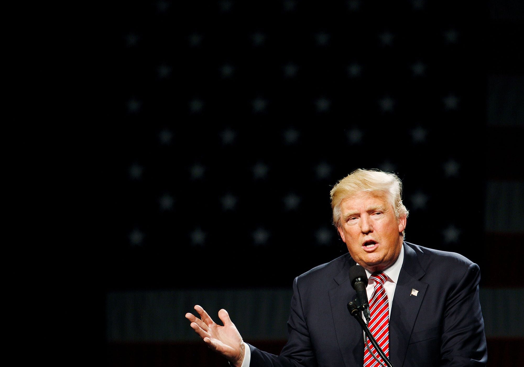 Donald Trump speaks at a podium during a 2016 campaign rally.