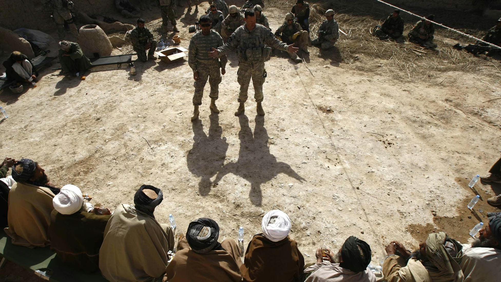 U.S. and Afghan personnel meeting with local Afghan village elders during a security discussion in rural Afghanistan amid the U.S. war effort