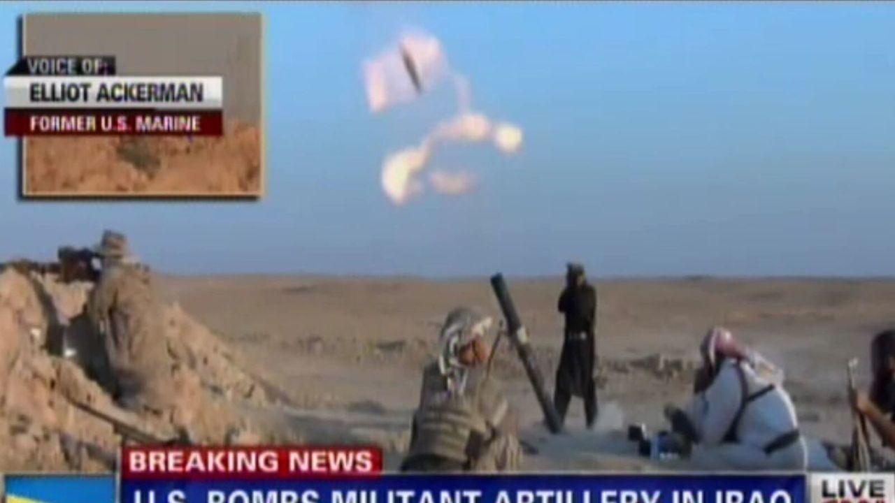 CNN Newsroom broadcast showing footage of militants firing artillery in Iraq while an on-screen graphic identifies Elliot Ackerman as a former U.S. Marine speaking by phone.