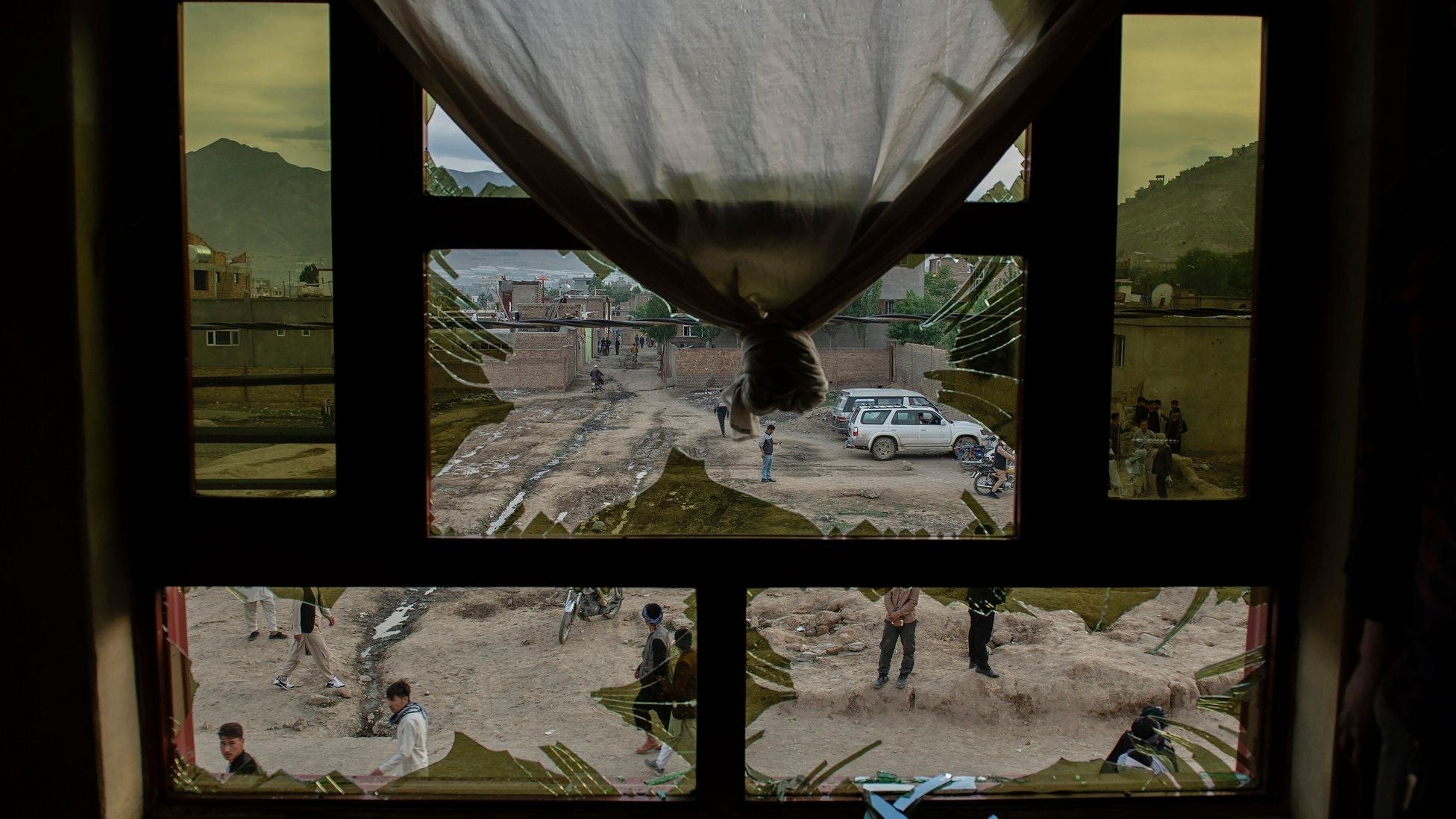 Broken window with shattered glass overlooking a street in Afghanistan.