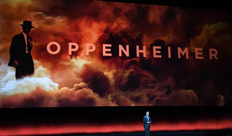 Promotional image for Christopher Nolan’s Oppenheimer, featuring the silhouette of J. Robert Oppenheimer against fiery clouds and smoke, with the film title displayed prominently across the center.