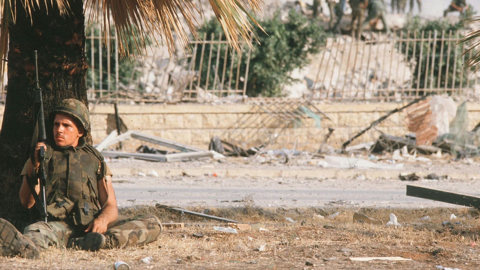 Marine sitting beneath a palm tree in Beirut, Lebanon