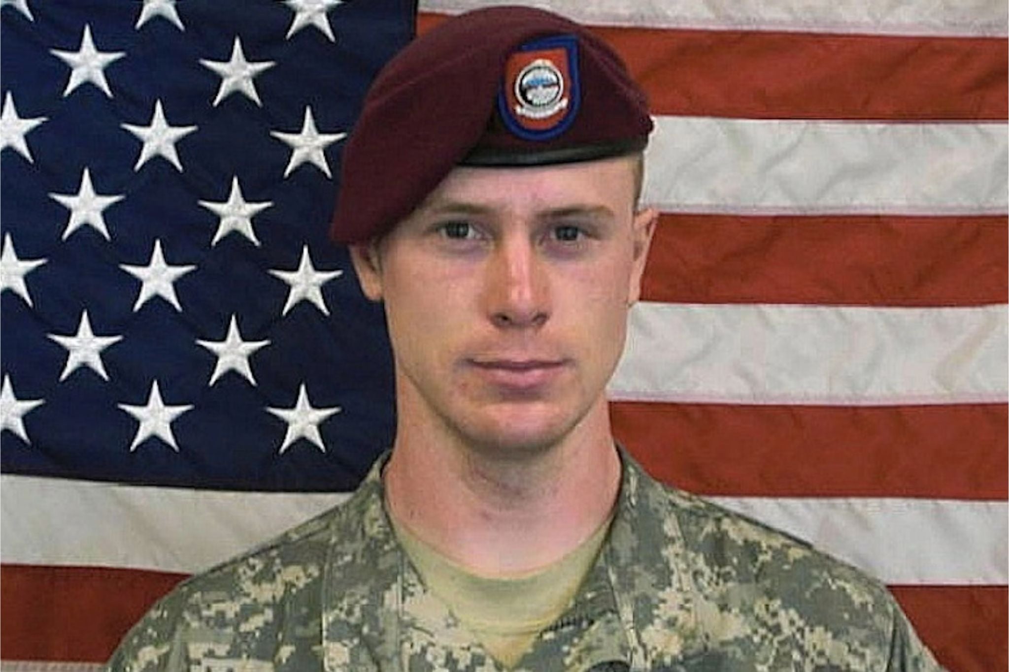 Official U.S. Army portrait of Bowe Bergdahl in camouflage uniform and maroon airborne beret, standing before an American flag prior to his disappearance and capture in Afghanistan.