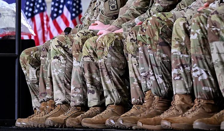 U.S. military service members seated in uniform during a public event, illustrating themes of military ethics, lawful orders, international law, and the responsibilities of troops during armed conflict.