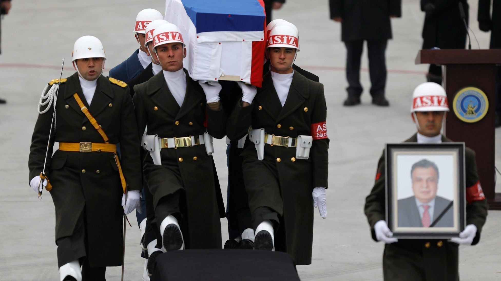 Turkish honor guards carry the flag-draped coffin of Russian Ambassador Andrey Karlov during a formal state funeral ceremony.