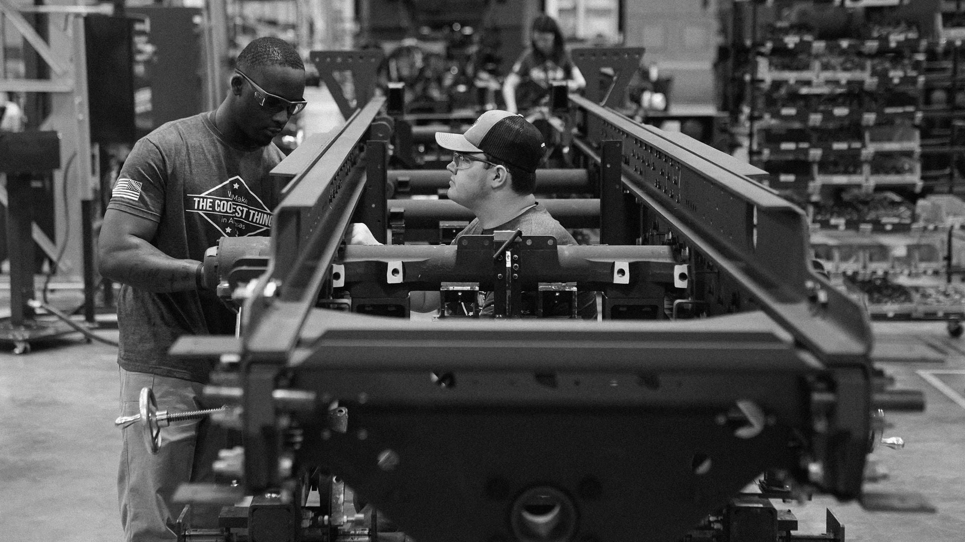 Workers assemble military rocket launcher systems on a production line inside a Lockheed Martin manufacturing facility in Camden, Arkansas.