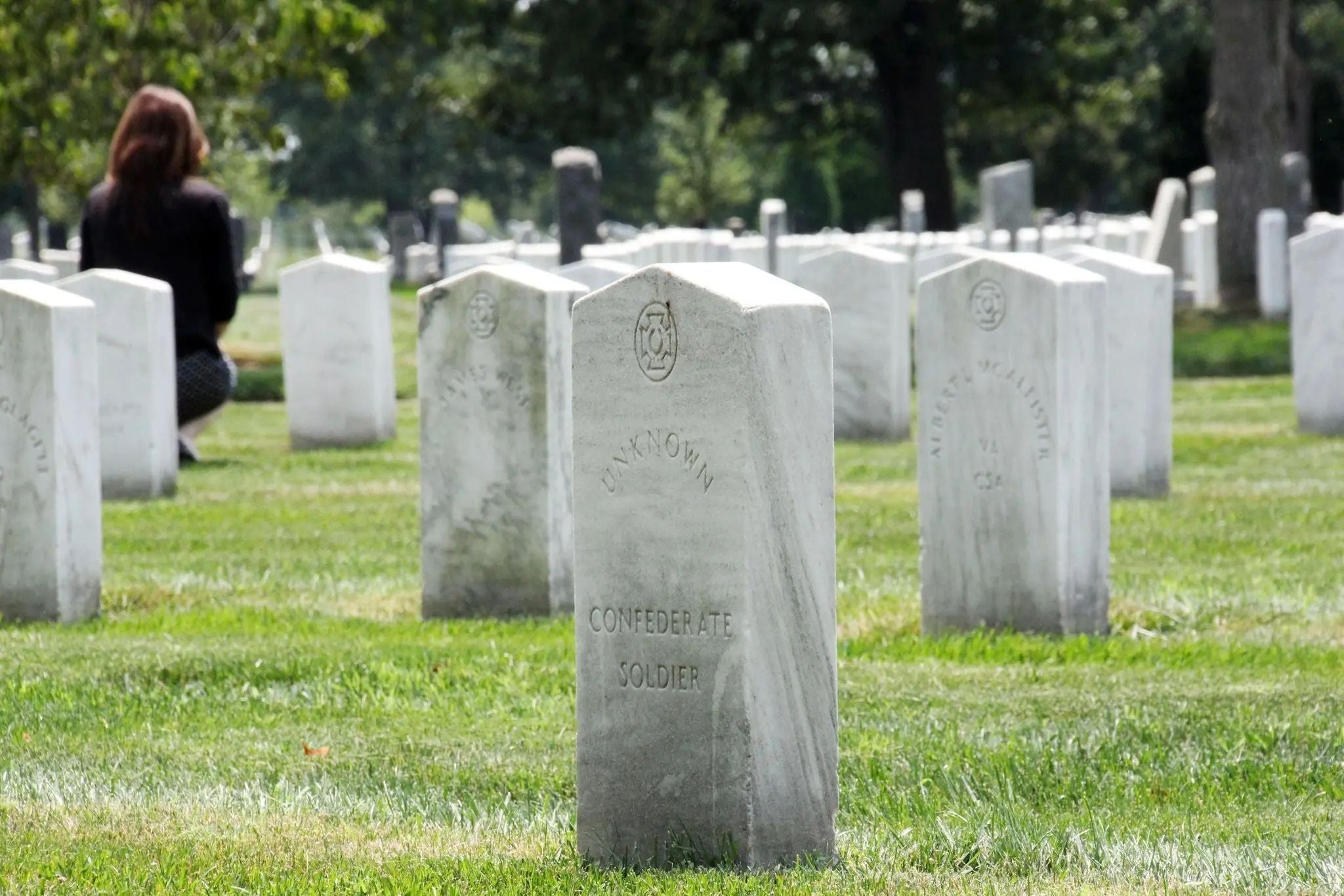 Confederate grave markers in the Confederate section of Arlington National Cemetery, including a headstone labeled "Unknown Confederate Soldier,"