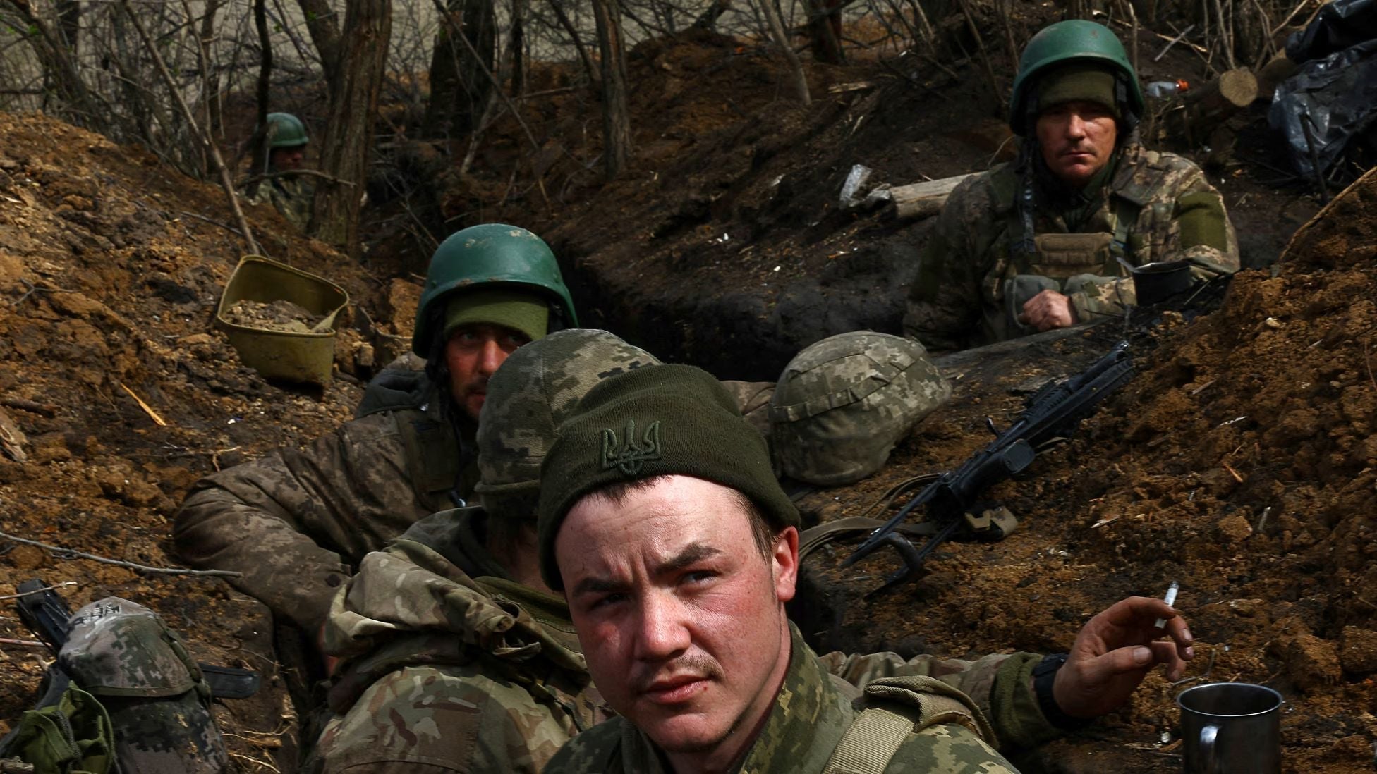 Ukrainian soldiers shelter in a frontline trench during the Russia-Ukraine war, pausing amid combat operations in eastern Ukraine.