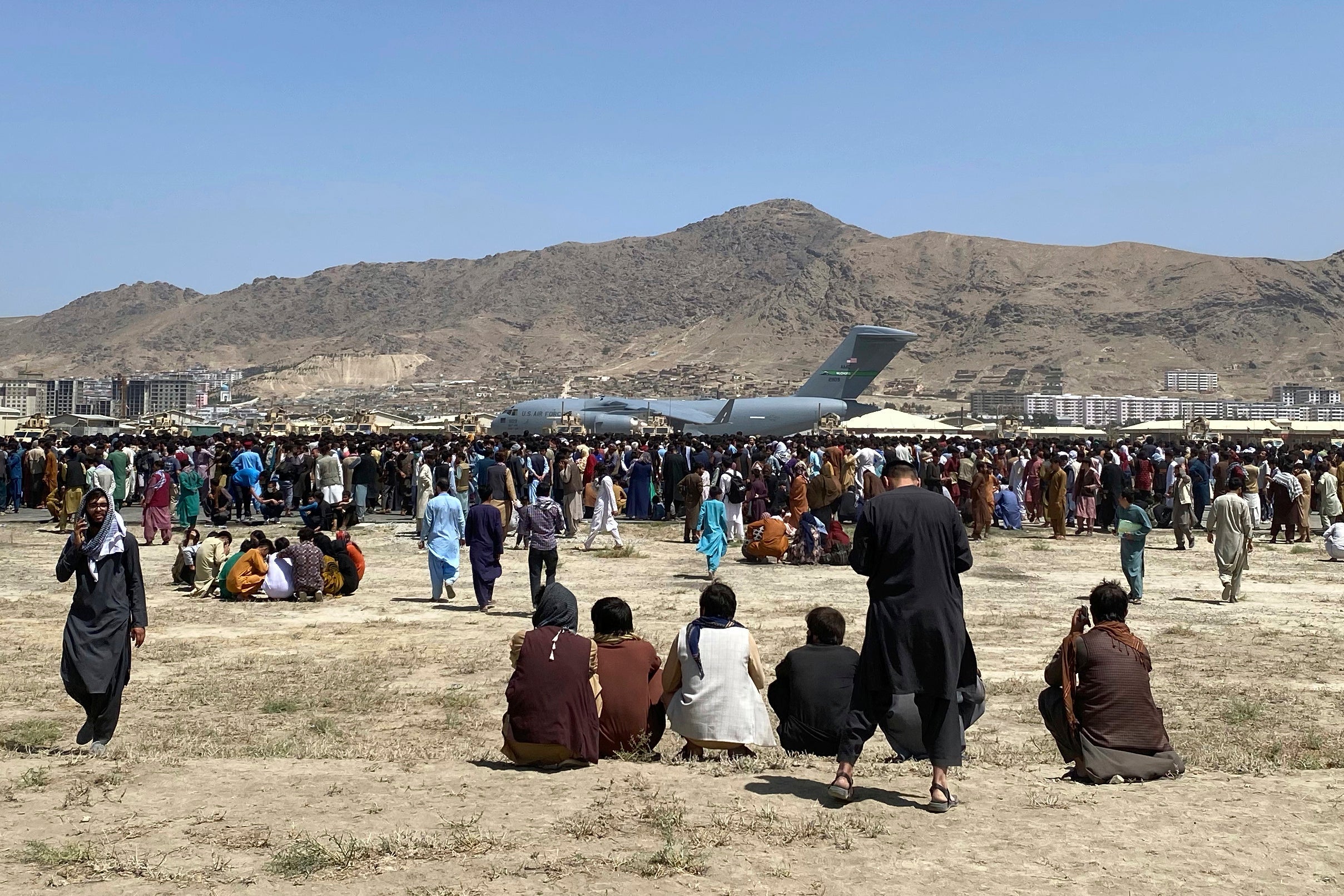 Crowds of Afghans gather near a U.S. Air Force C-17 at Kabul's airport during the 2021 evacuation.